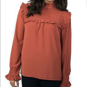 Ruffle neck and sleeve top in rust
